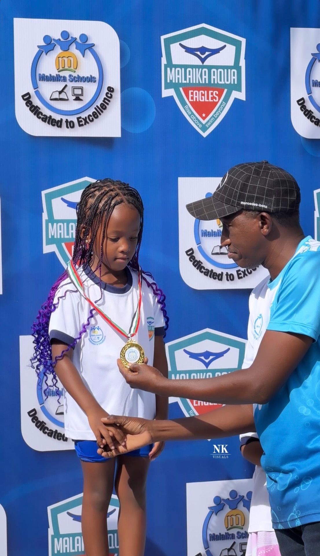 Child receiving a medal at a school swimming event